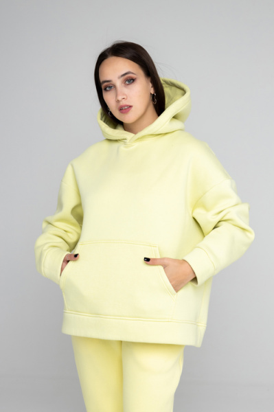 Эта оверсайз толстовка создана в духе современных требований, предлагая стиль и комфорт в одном изделии. Изготовленная из мягкого футера с начесом, она обеспечивает тепло и уют. Пояс и рукава обработаны кашкорсе для дополнительного комфорта и износостойкости. Двухслойный капюшон, с возможностью исполнения со шнурком или без, добавляет универсальности и функциональности. Внутренний слой капюшона выполнен из основной ткани, что подчеркивает внимание к деталям. Нанесите свой логотип, и ваша команда будет выделяться, создавая уникальный и запоминающийся образ.
Толстовка оверсайз объема, рукав втачной со спущенной линией плеча, низ обработан манжетой из кашкорсе, на полочке накладной карман «кенгуру». Горловина имеет втачной капюшон из двух деталей с подкладкой из основной ткани, имеет кулиску со шнуром, вставленным в выметанные петли (может быть без шнурка). Верхний капюшон отстрочен по среднему шву на плоскошовной спецмашине. Низ изделия обработан поясом из кашкорсе. Длина изделия до середины бедра. Декоративные отстрочки на плоскошовной спецмашине по плечевому шву и шву проймы.